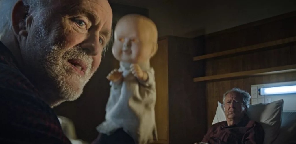 John Lithgow as Crealy, holding hand puppet