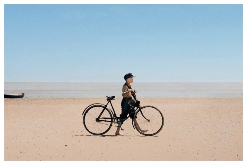 Boy in HJ uniform walking on beach
