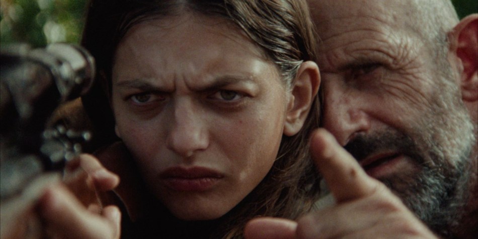 Girl practicing shooting with help of father