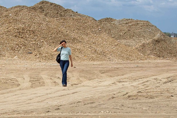 Woman walking along building site