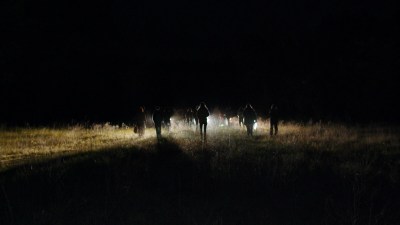 People gathering on a field at night