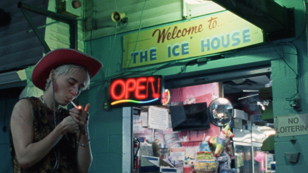 Young woman lighting a cigarette in front of store
