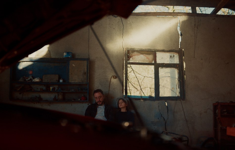 Esma and her father in destroyed home