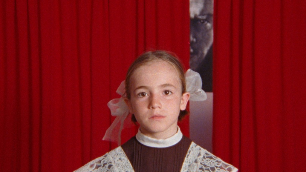 Young girl in school uniform facing camera