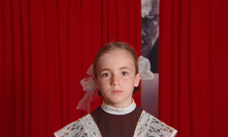 Young girl in school uniform facing camera