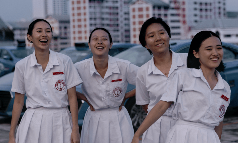 The Girl Gang together in their school uniforms, laughing