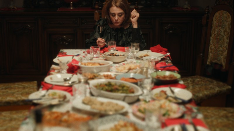 Woman eating by herself alone a lavish dinner table
