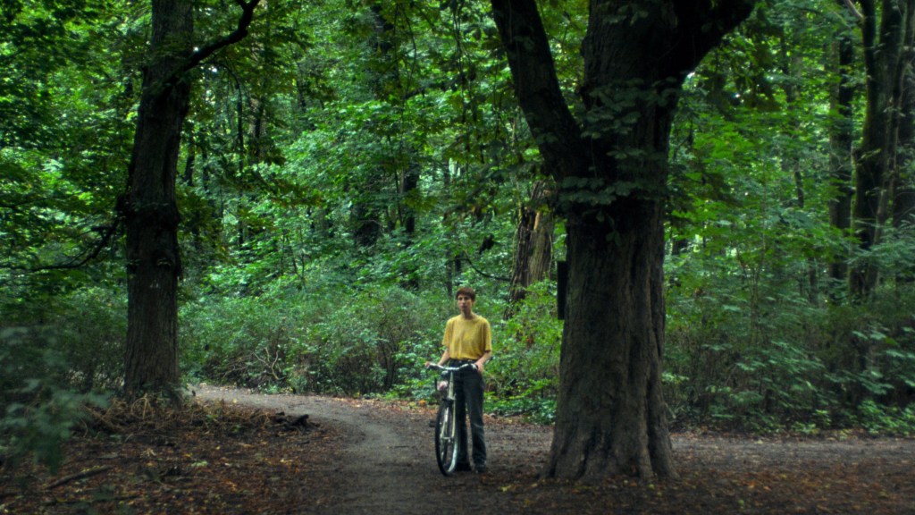 Carla in the park, stand with her bicycle