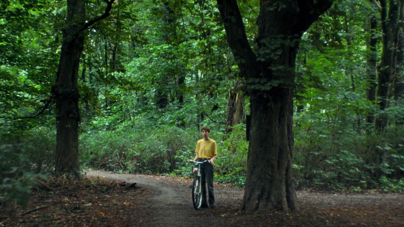 Carla in the park, stand with her bicycle