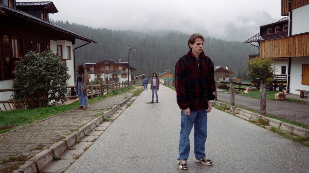 Matteo standing motionless on village street