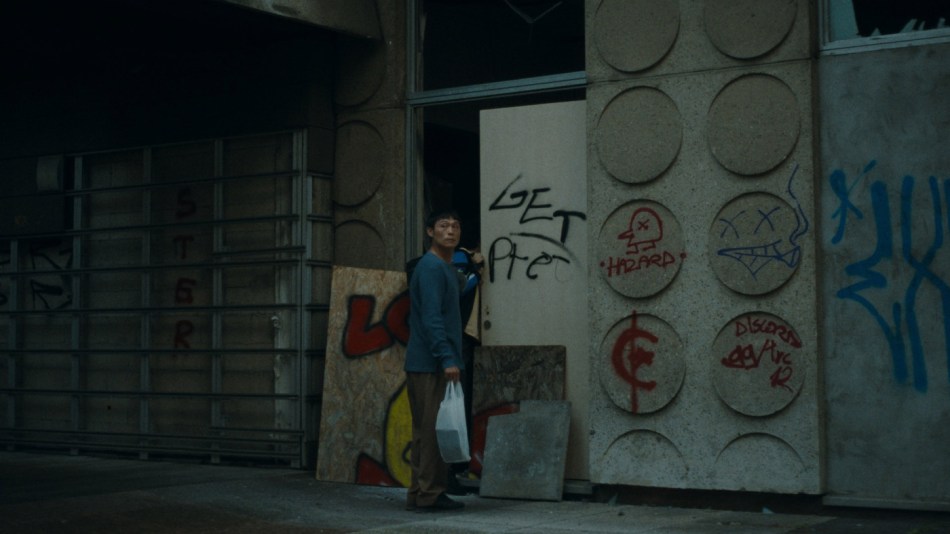Yi-En in front of their house with groceries