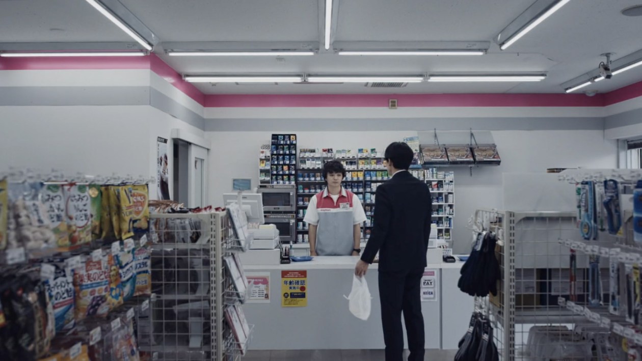 Sakai behind counter in konbini