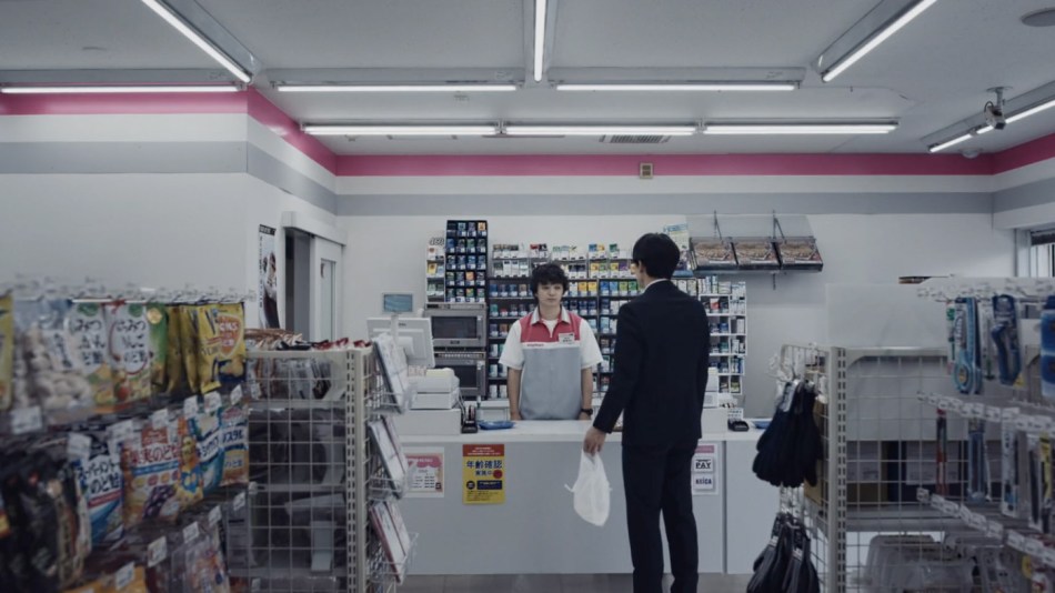 Sakai behind counter in konbini
