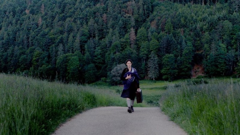 Emma walking down lonely road