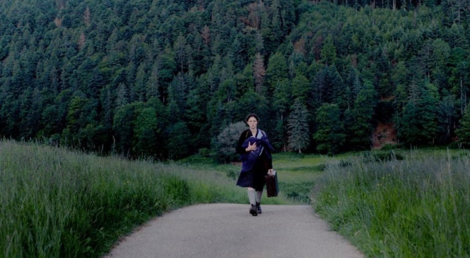 Emma walking down lonely road